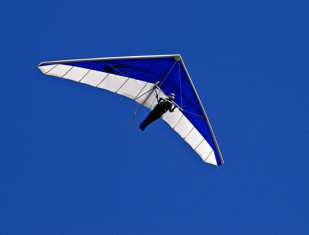 Hang-glider flying through the blue sky