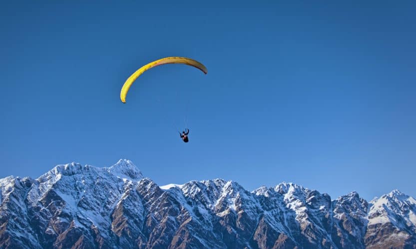 Paraglider above Remarkables range, Queenstown, Otago, New Zealand